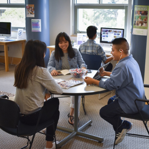 Students sitting at a table conversing